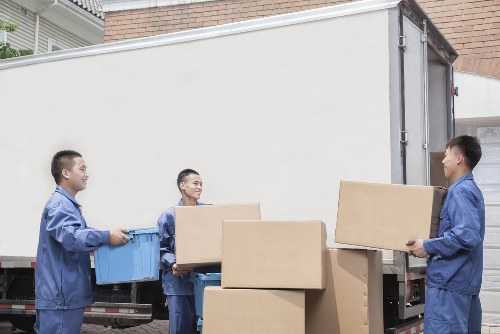 Specialist piano movers handling a piano in a Haringey home