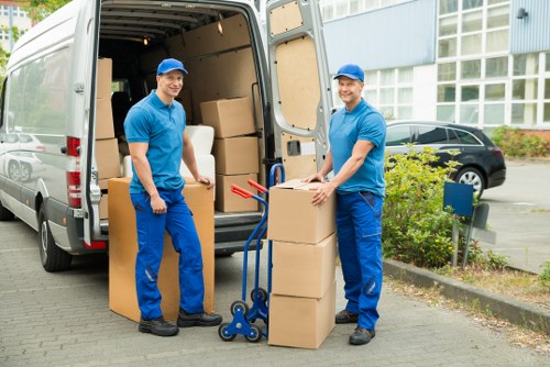 Furniture and boxes being moved by a man with van team