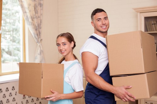 Trained movers handling furniture carefully inside a Haringey property